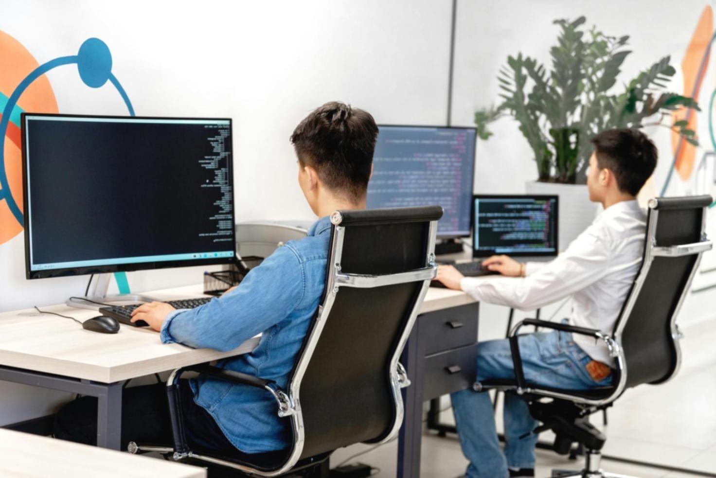 Developer team collaborating on debugging session with live code analysis